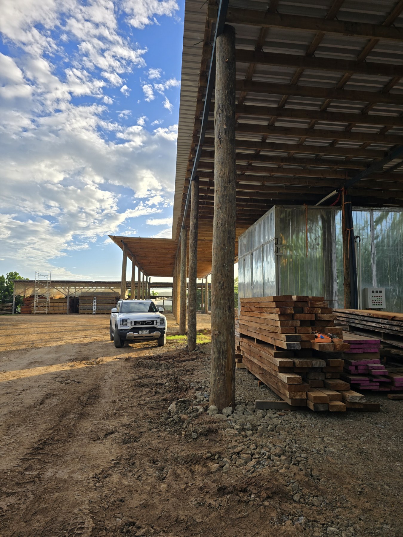 Timber stacks beside the kiln and covered processing area